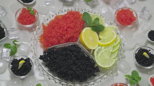 Red and black caviar in dishes. Salmon caviar and black Beluga sturgeon salted roe