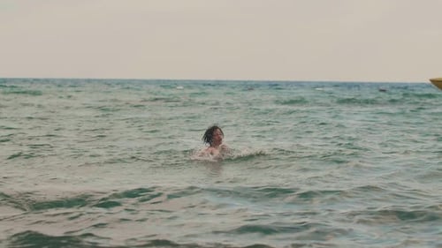 Cute Teen Age Boy Having Fun Swimming Relaxing Alone in Warm Summer Sea on Vacation Yellow Leisure