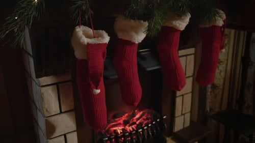 Festive Stockings Hanging Above Burning Fireplace