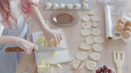 Woman Dicing Apples in a Bright Kitchen