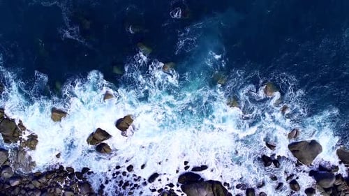 Foaming Waves Crash Aerial View of Ocean Water and Coastal Rocks