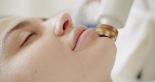 Young Woman Receives Beauty Treatment on Face