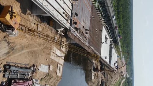 Vertical Video Aerial View of the Construction of a Bridge Across the River