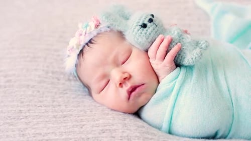 Adorable Newborn Lies on Bed with Favorite Plush Toy