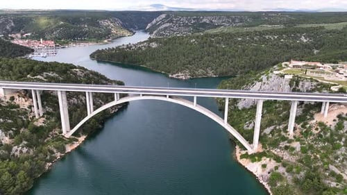 Drone flight above a beautiful arch bridge near the town of Shibenik in Croatia