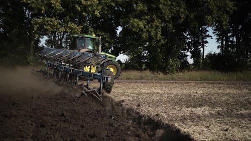 Tractors plowing the field in Ukraine