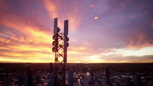 A Tall Cell Tower Stands Against A Vibrant Sunset