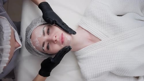 Woman Receiving Facial Massage in Spa