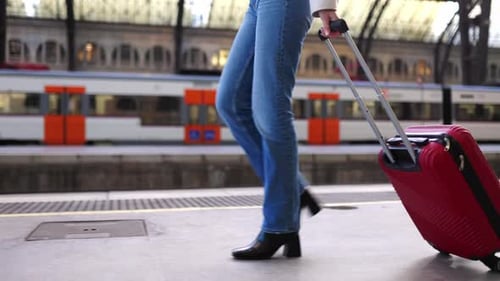 Young Traveler Woman with Travel Suitcase Walking at Train Station Platform