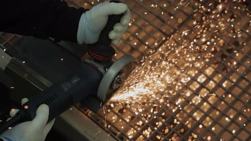 Metal Grinding Sparks with Angle Grinder at Workplace