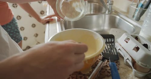 Closeup, hands and batter in bowl at home for breakfast, pancakes and whisk together to mix flour