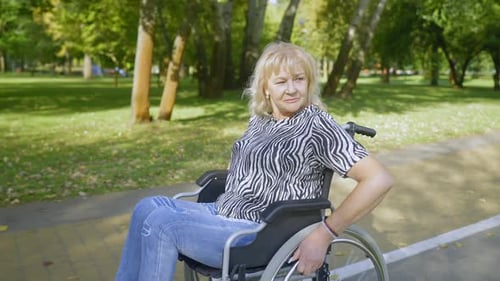 Portrait of Senior Female Wheelchair User Spending Active Lifestyles in Park