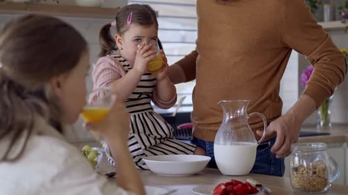 Happy Family Having Breakfast Together in Kitchen