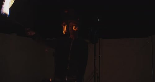 Skilled Young Adult Fire Juggling Performer at Night