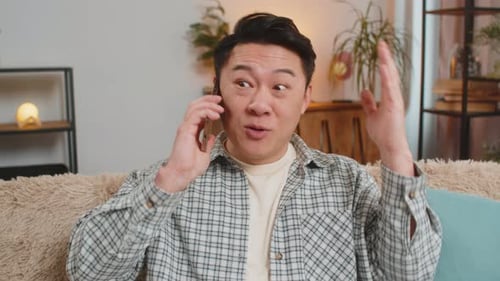 Man Talking on Smartphone at Home Indoors