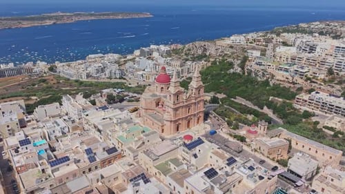 Drone footage of the Mellieha Parish Church with its iconic red dome and twin bell towers,