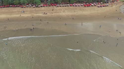 Aerial view of tourists enjoying a tropical sandy beach