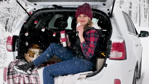 Woman Enjoying Winter Snack in Snowy Woods