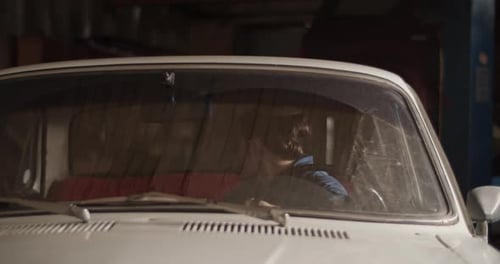 Man Driving Car Out Garage