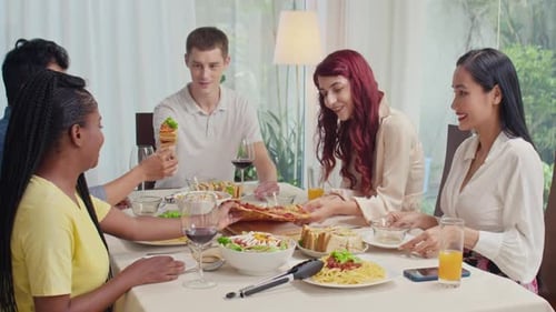 Friends Sharing Pizza and Pasta at a Home Meal