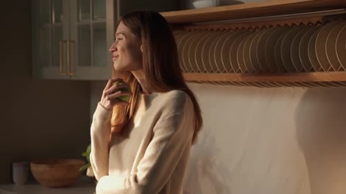 Woman with Apple in Bright Kitchen