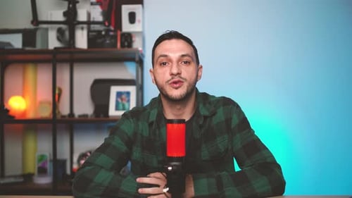 Man Hosting a Podcast Show with Pro Audio Equipment in a Minimalist Studio Setting