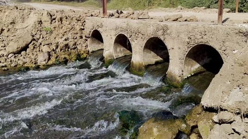 Bridge culvert water flowing in natural stream