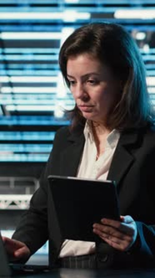 Vertical Video Data Center Specialist Crosschecking Settings Between Laptop and Tablet