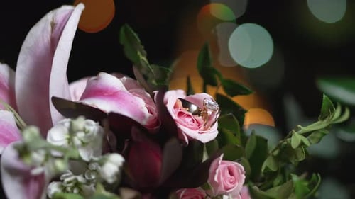 Wedding Rings Displayed on Pink and White Flowers