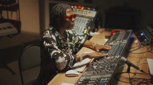 Black Music Producer Mixing and Enjoying Sound in Recording Studio