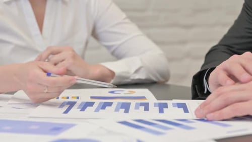 Close up of Business People Doing Paperwork in Office