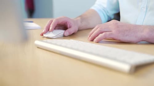 Close-up of a businessmen man's hands typing a desk on a keyboard. Man working on computer at table