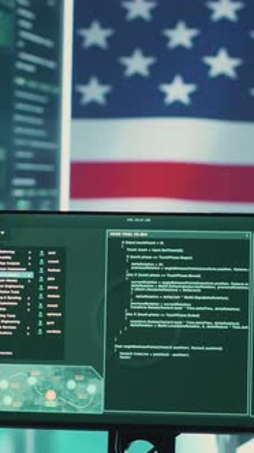Computer Screens Displaying Code with American Flag