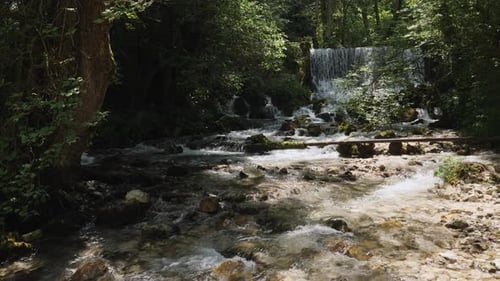 An amazing beautiful waterfall view of the river streaming on the rocks in the forest.