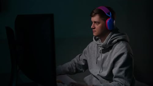 Young Adult Gaming at Computer at Night