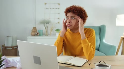 African Woman Touching Temples Experiencing Stress