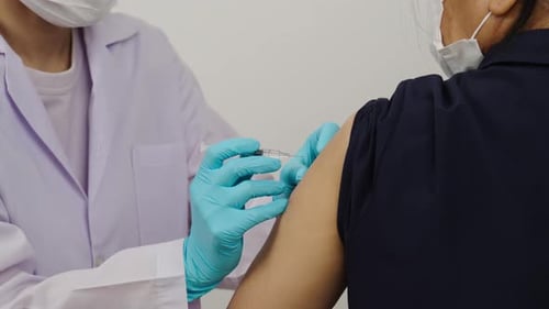 Medical Professional Giving an Injection to Patient