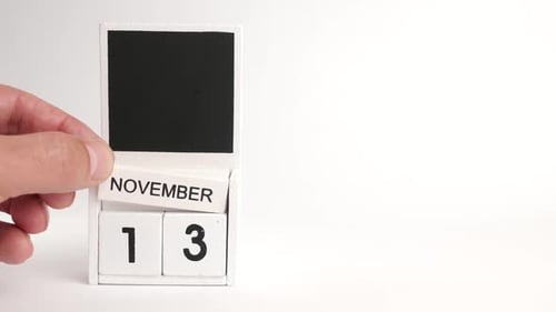 Close Up Hand Sets Calendar to November Thirteenth