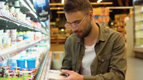 A Man Shopping Dairy Product in Grocery Store Side View of Handsome Man Buying Ice Cream