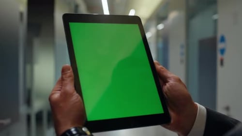 Hands Holding Tablet with Green Screen in Office