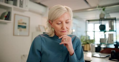 Confident Senior Woman Thinking in Modern Office