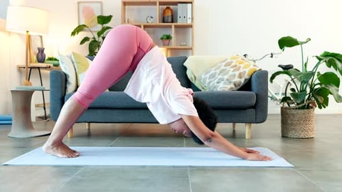 Yoga woman stretching in downward and upward facing dog pose to aid mobility in her back