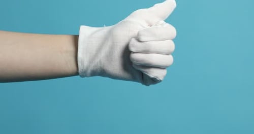 Gloved Hand Giving a Thumbs Up on Blue Background