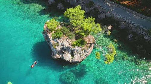 Aerial top down view of serene atmosphere and clear sea waters with idyllic summer beach in Brela, C