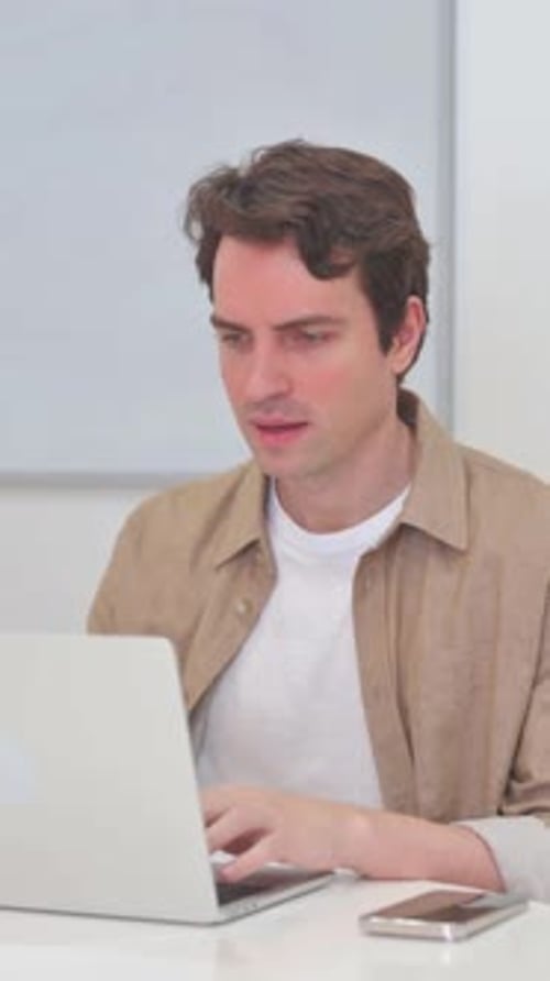 Excited Young Man Working on Laptop Computer