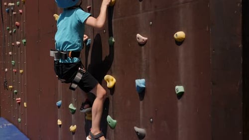 Boy Climbing Artificial Rock Climbing Wall