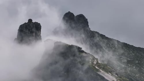 Fog Rolling Over Mountain Peaks and Cliffs