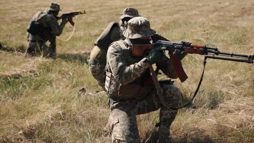 Armed Soldiers in Field Training Exercise