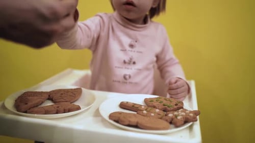 Adorable Child Decorates Cookies with Frosting