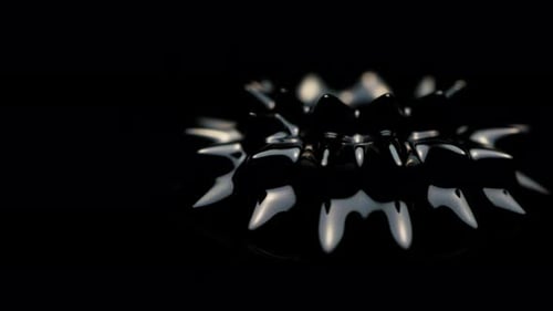 Close-up Of Black Ferrofluid Spinning To The Left